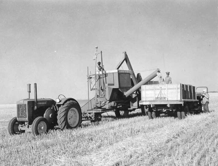 Unloading grain from pull-type combine into truck