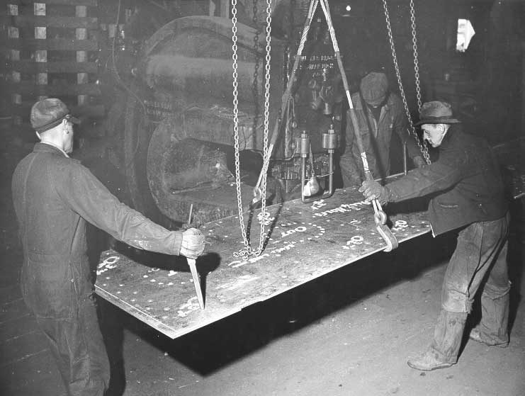 Prince Rupert shipyard : workmen operating large punch press in machine shop