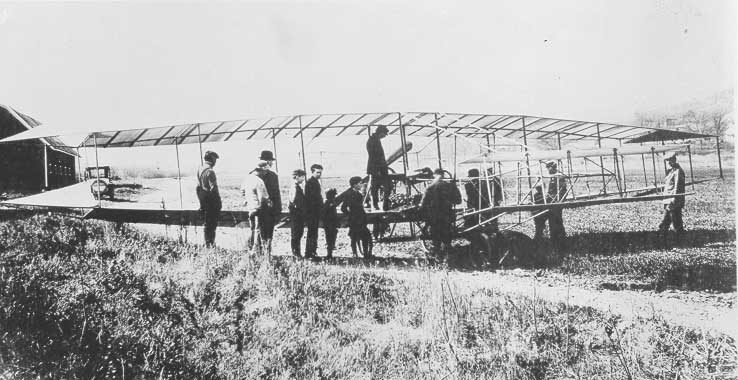 Adults and children admiring the Silver Dart
