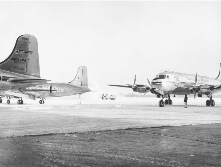 A winter scene with three Canadair DC-4M North Stars