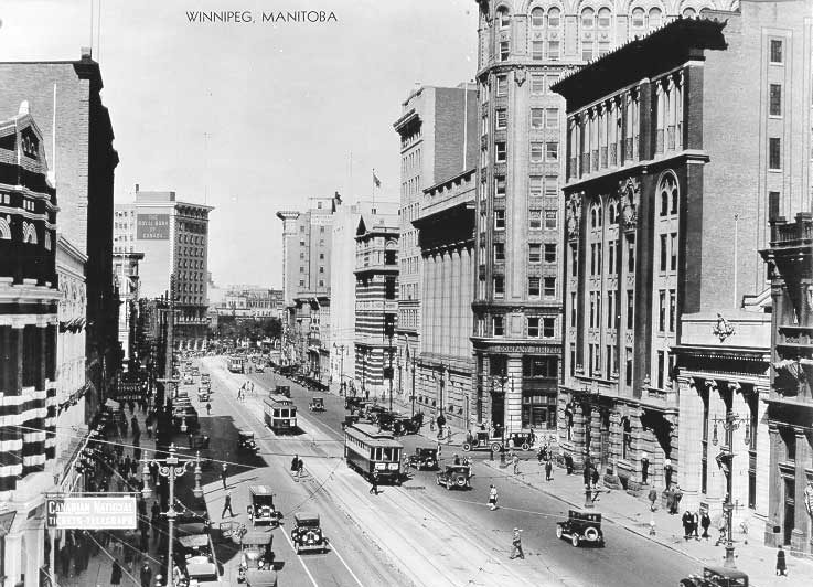 View looking north of streetcars along Main Street from the intersection at Portage Avenue