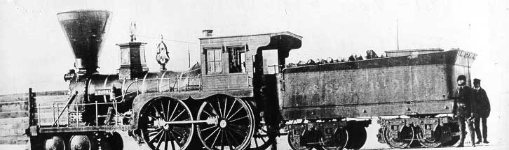 The crew of the Atlantic and St. Lawrence Railroad locomotive Coos pose beside their locomotive on a frigid winter day