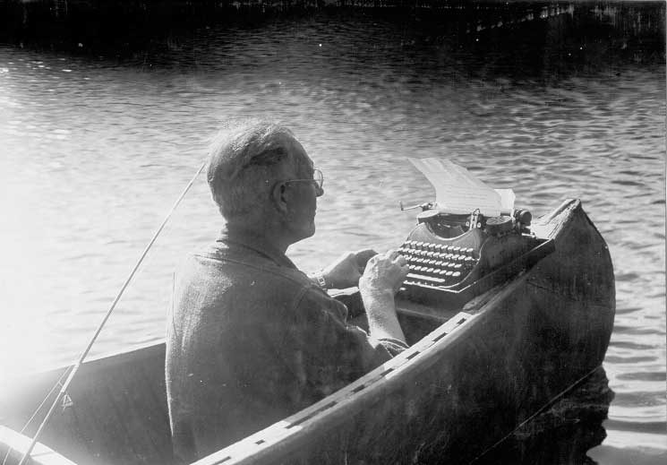 V.B. Gray writing a story in a canoe
