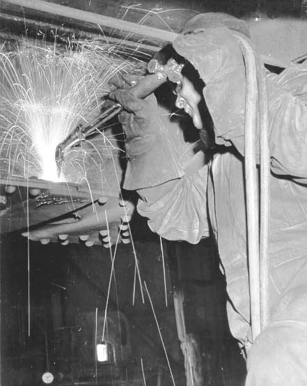 Using a cutting torch in Pointe-Saint-Charles wheel shop