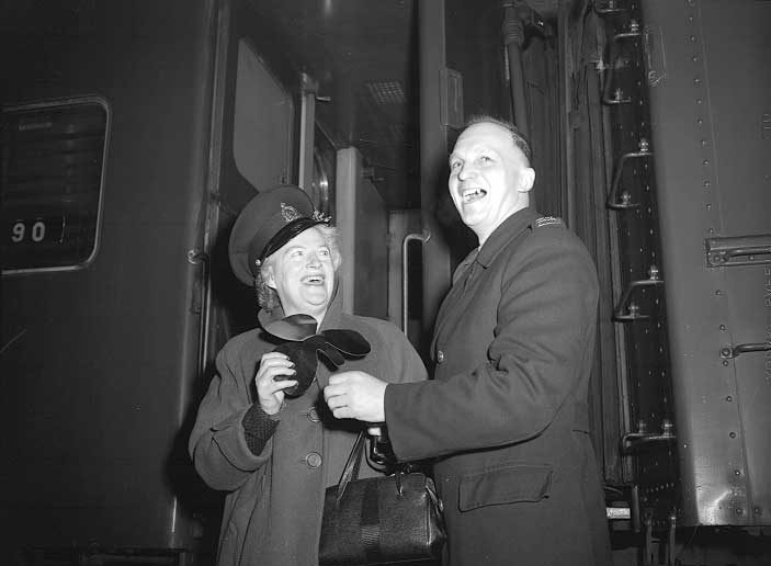 Entertainer Gracie Fields borrows Constable Alcock's headgear