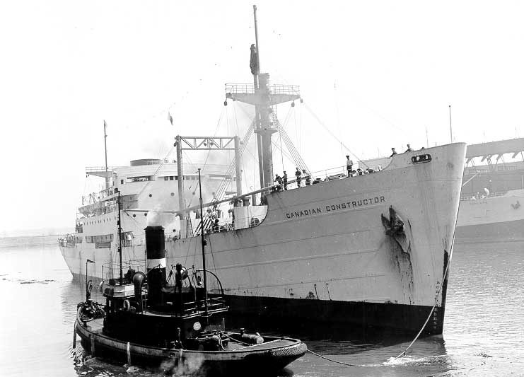 Passenger/cargo ship MV Canadian Constructor being pulled by a tug