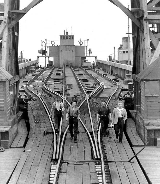 CN freight car barge No. 109 and tugboat No. 1 seen through a CN barge and ferry slip
