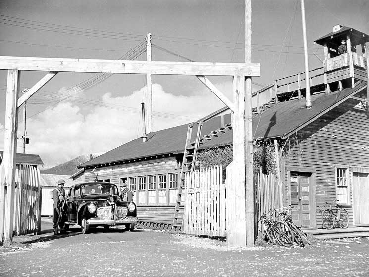 Military guards at the Prince Rupert shipyard and dry dock halt cars to inspect passes