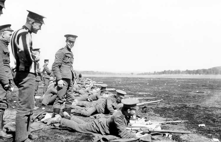 Soldiers lined up to practice shooting at a WWI training camp