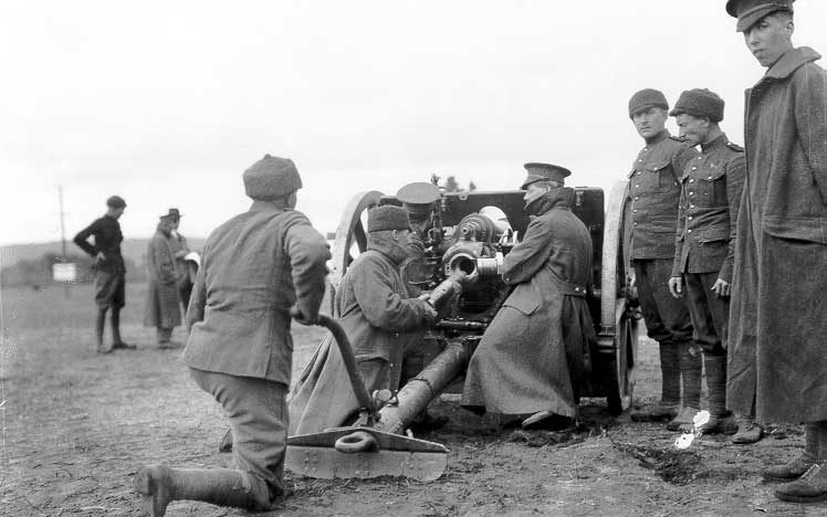 Soldiers load a gun at a WWI training camp