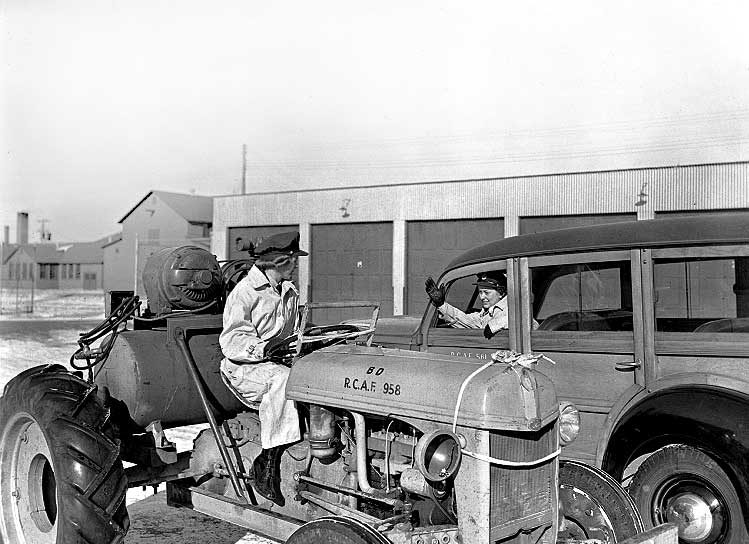Members of the RCAF Women's Division driving a tractor and a truck