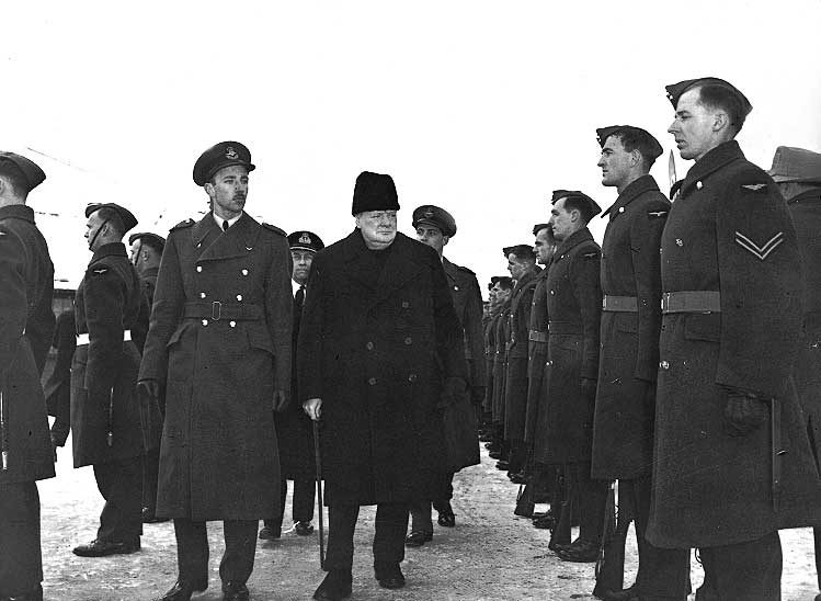 Great Britain's PM Sir Winston Churchill inspects an RCAF guard during his visit