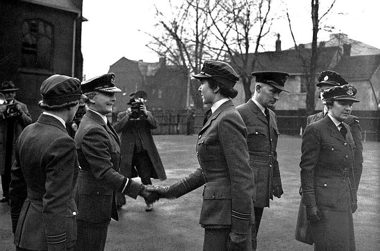 Princess Alice, Chief Commandant of the Women's Auxiliary Air Force, shakes the hand of a WAAF member