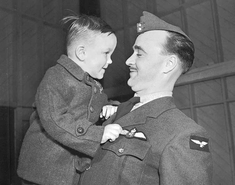 Dad shows his son his new pilot's wings