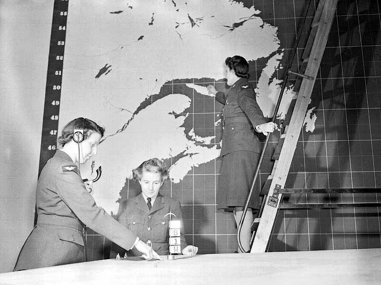 Members of the RCAF Women's Division at work in an operations room in Eastern Canada