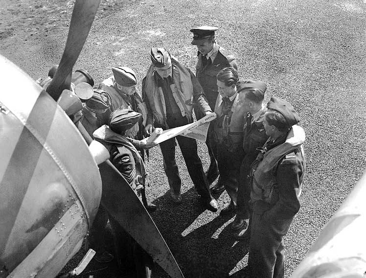 Aircrews of an RCAF Blenheim Fighter Squadron of Coastal Command read a new RCAF overseas newspaper