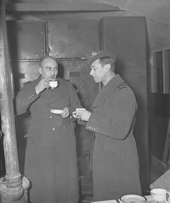 King George VI has tea with air and ground crew in the RCAF Fighter Squadron's dispersal hut