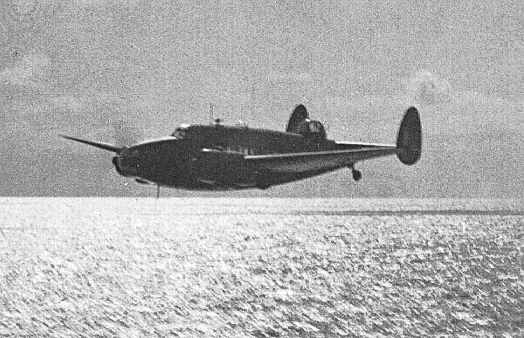 An RCAF Hudson skims over the water looking for a torpedo bomber aircraft forced to land in the sea