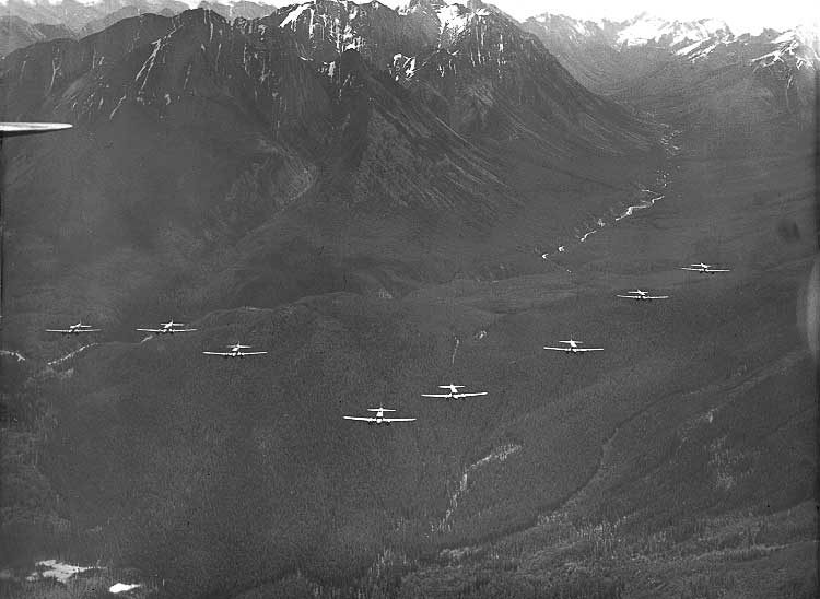 RCAF Avro Ansons fly in formation through the mountains