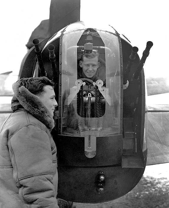 Canadian and American Air Gunners attached to an RCAF Squadron test the guns and turret of a bomber