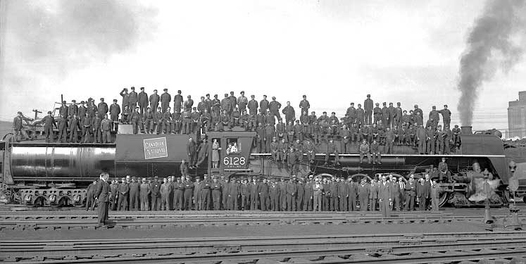 Workers gather on CN locomotive 6128 to hear a victory speech