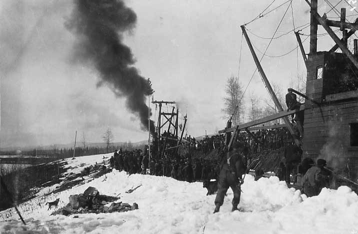 Track-laying machines meet at mile 1372.7 to complete the Grand Trunk Pacific Railway