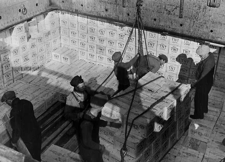 Loading TNT into a cargo ship hold