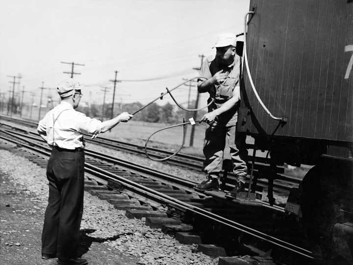 Exchanging written train orders with a moving train