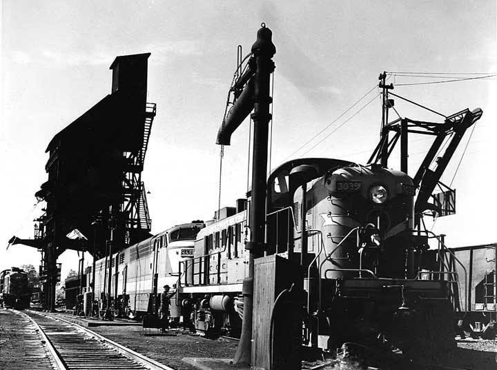 Canadian National Railways locomotives 3039 and 9330 at St. Albans yard with coal tower and a stand pipe