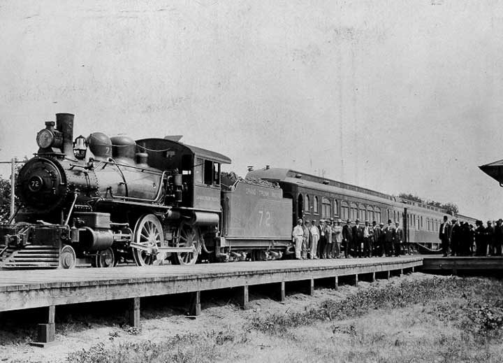 Grand Trunk Pacific Railway Company steam locomotive no. 72 and passenger train at a station