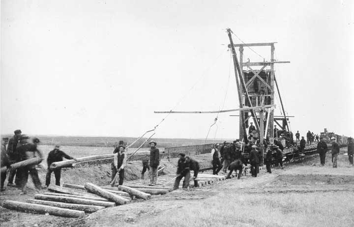 Track layer constructing Grand Trunk Pacific Railway line at Lazare Bridge in western Canada