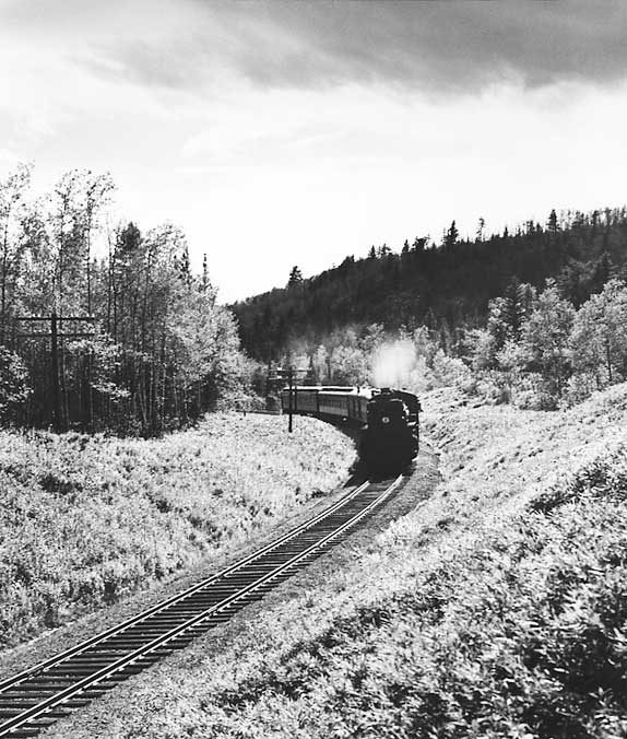 A Canadian National Railways passenger train rounds a curve