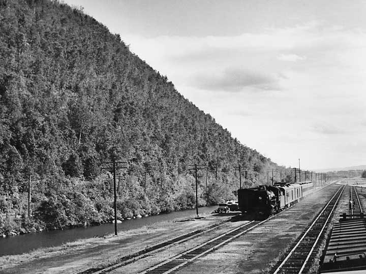 A Canadian National Railways passenger train in mountainous terrain