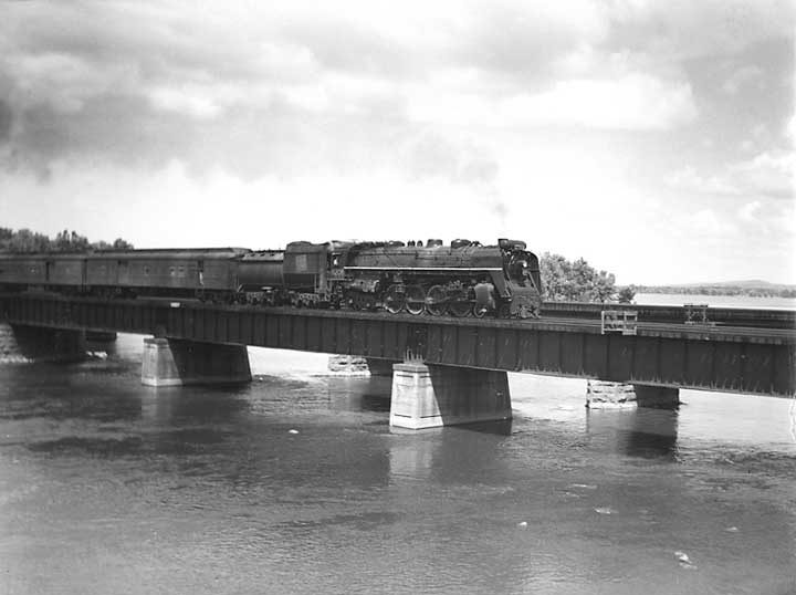 Canadian National Railways steam locomotive no. 6208 hauls a passenger train across St. Anne's Bridge between Île-Perrot and Dorion
