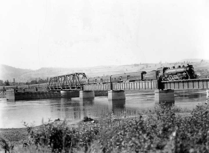 A Canadian National Railways passenger train crosses the Thompson River Bridge