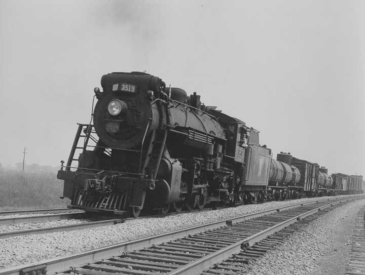 Canadian National Railways steam locomotive no. 3519 hauls a freight train through Cobourg