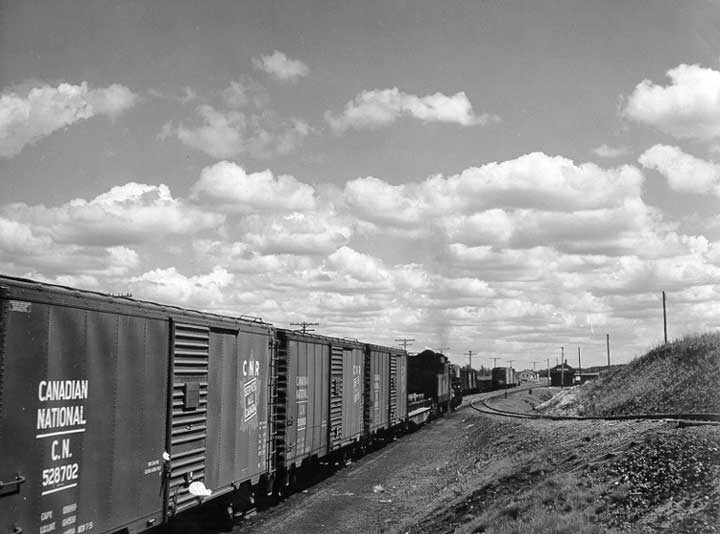 A Canadian National Railway freight train approaches a railway station in Touchwood