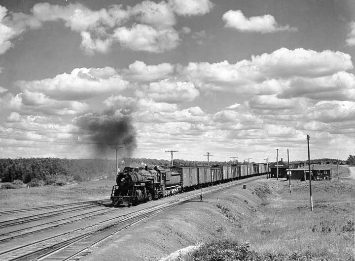 A Canadian National Railway freight train steams past Touchwood Station