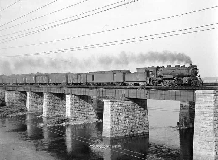 Canadian National Railway steam locomotive no 3328 hauls a freight train across St. Anne's Bridge near St. Anne de Bellevue