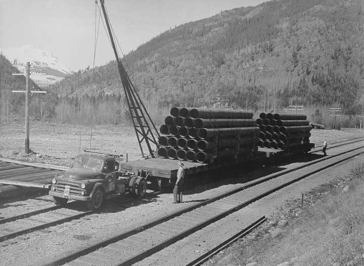 Unloading sections of pipe for the Trans Mountain Pipe Line