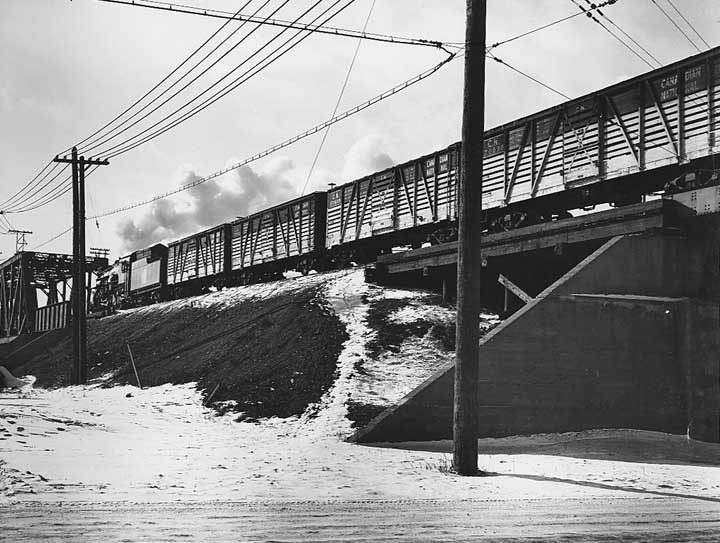 A Canadian National Railways stock train approaching a bridge