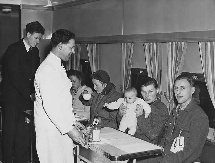 A family of displaced persons on a dining car
