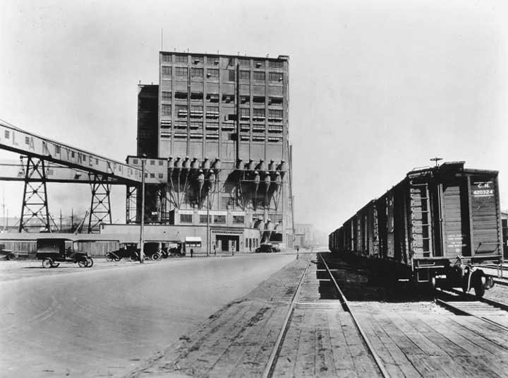 Canadian National Railway freight cars beside the Vancouver Harbour Commission elevator and offices