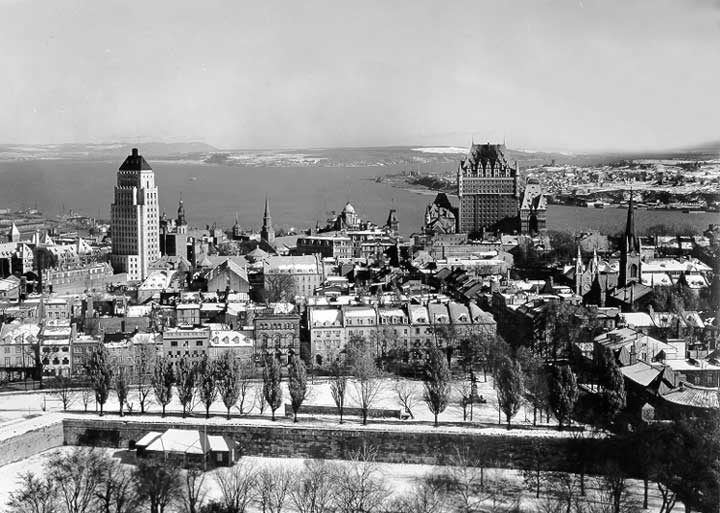A cityscape from the Parliament Buildings looking towards the St. Lawrence River; Chateau Frontenac is at centre right; Price Building at left