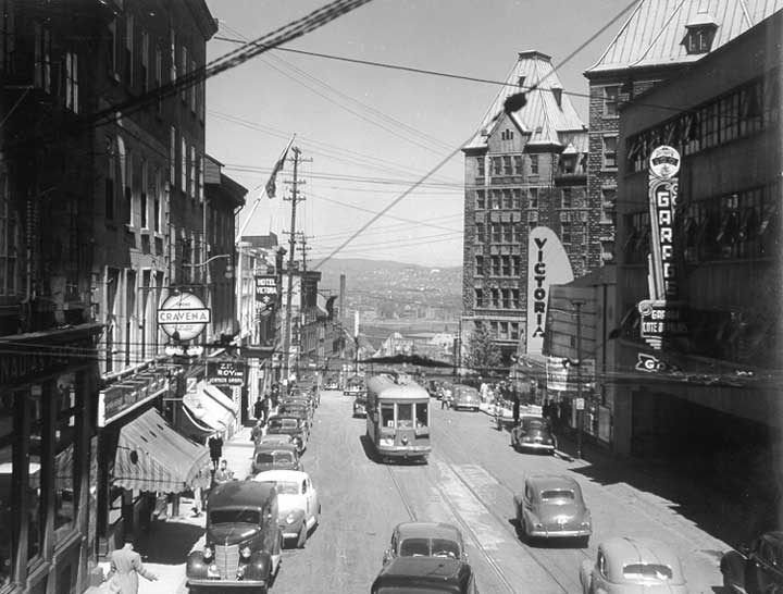 A street railway car on a busy street in the old city of Québec