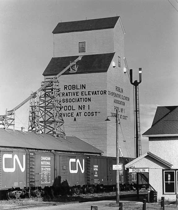 Canadian National Railway freight cars beside a grain elevator