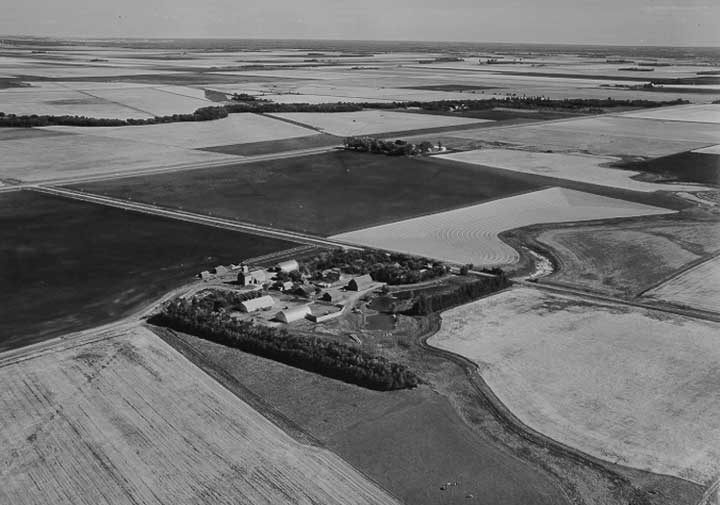 An aerial view of prairie farm buildings