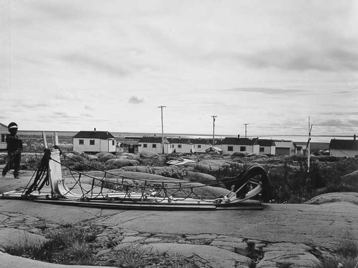 A dog sled outside an Amerindian village