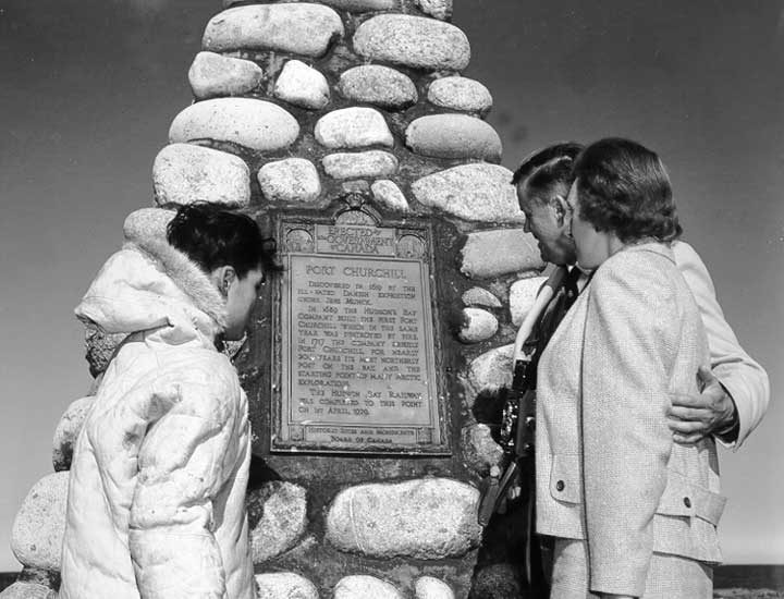 Tourists examine historic marker for Fort Churchill
