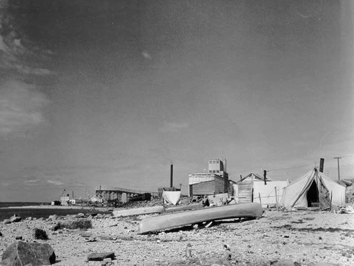 An Aboriginal settlement with the harbour and grain elevator in the background